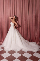 Off-white strapless lace A-line wedding gown side view and cathedral train