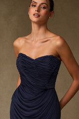 Close-up of gathered sweetheart neckline and ruched navy evening gown bodice
