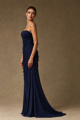 Side view of navy blue floor-length ruched formal gown