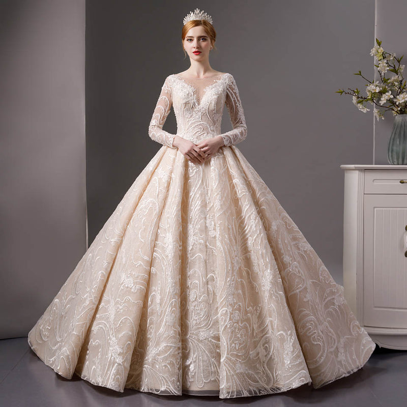 High volume tulle skirt wedding gown with full sleeve royal bodice in white